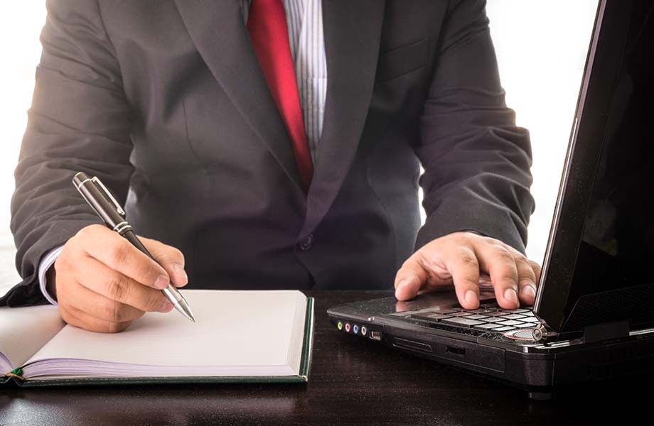 business man working with laptop, close up of hands hold a pen of business man